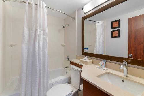 a bathroom with a sink and a toilet and a mirror at Comfort Inn Manchester Airport in Manchester