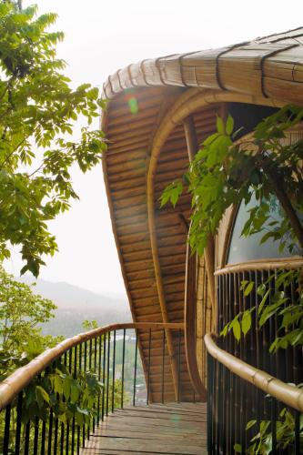 a wooden walkway on the side of a building at Cocoon Reserve in Kuta Lombok