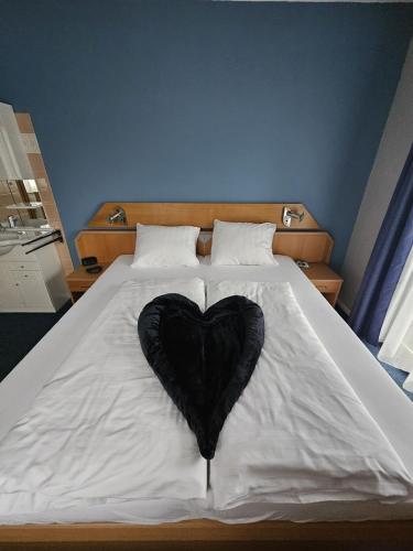 a black heart is laying on a bed at Mirnockblick Apartments 2 in Radenthein