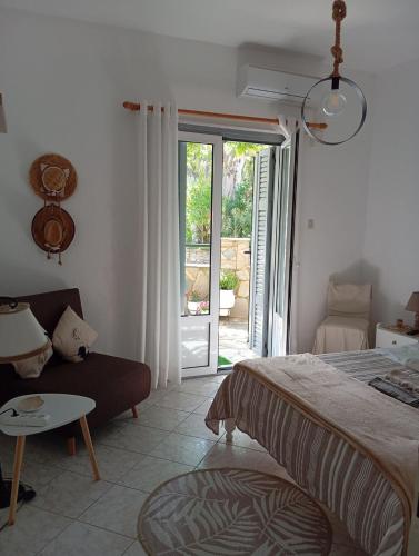 a bedroom with a bed and a couch and a sliding glass door at Maria I in Chorto