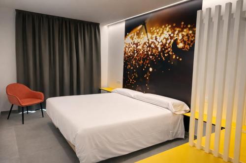 a bedroom with a bed and a painting on the wall at Pension Sarria in Sarria