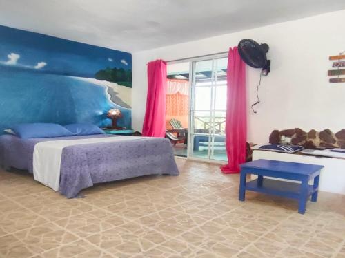 a bedroom with a large bed with pink curtains at House Jardin Del Caribe in Las Terrenas