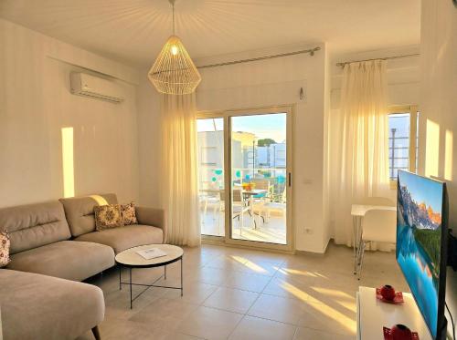 a living room with a couch and a table at Sunny Beach Apartments - 146 in Mullini i Danit