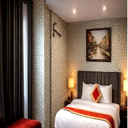 a hotel room with a bed and a painting on the wall at rashik stayzz in Shimla