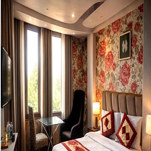 a bedroom with a bed and a chair and a window at rashik stayzz in Shimla