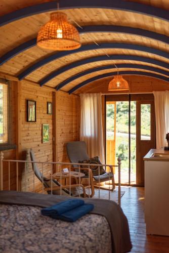 a bedroom with a bed and a table and chairs at Finca la montaña roja in Almogía
