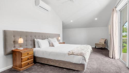a bedroom with a large bed and a window at Dashaz Dream - The Vintage in Pokolbin
