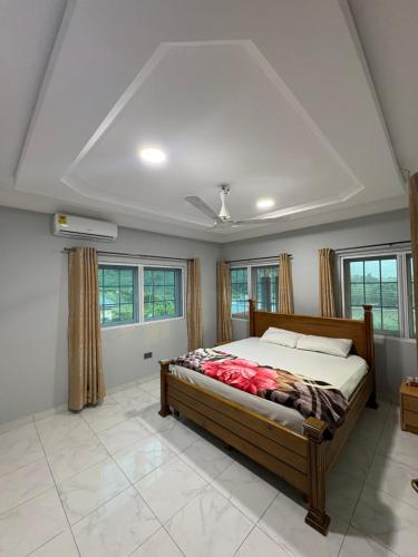 a bedroom with a bed in a room with windows at Ankyease Aclove in Kotrope