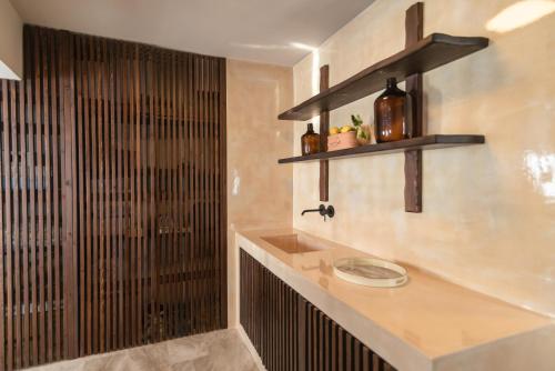 a bathroom with a sink and a shower at Archo Suites Pythagoreio in Pythagoreio