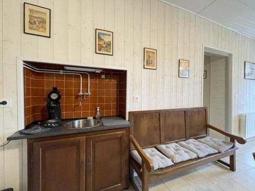 a kitchen with a sink and a bench in a room at Gite de l'isarce in Montaut