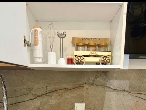 a kitchen cabinet with a toy train on a shelf at The Cozy Nook- luxury, privacy, with a pool and gym in Sukrah