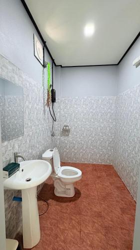 a bathroom with a toilet and a sink at Kohlibong forest house in Trang