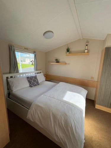 a bedroom with a bed in a small room at Static home sleeps 6 in Dawlish Warren
