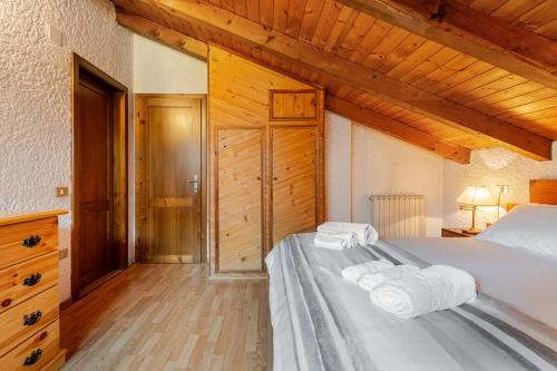 a bedroom with a bed with towels on it at Rifugio del Sole Apartment in Monclassico
