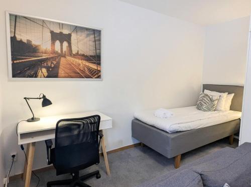 a bedroom with a desk and a bed and a desk at Forenom Hostel Gothenburg Säve in Gothenburg