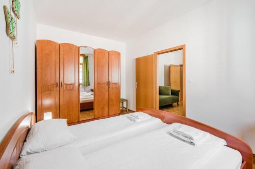a bedroom with a bed and a mirror at Apartments Rombon Klavdij with Free Onsite Parking in Bovec