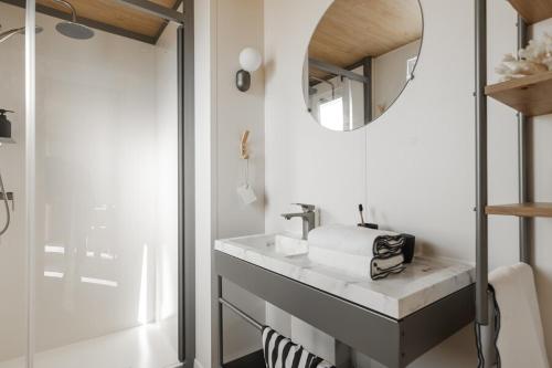 a bathroom with a sink and a mirror at CAMPING AZU'RIVAGE in Azur