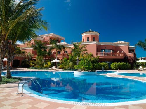 a resort with a swimming pool in front of a building at Hotel Las Madrigueras Golf Resort & Spa - Adults Only in Playa de las Americas