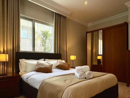 a bedroom with a large bed with towels on it at Villa Sunny Side in Mellieħa