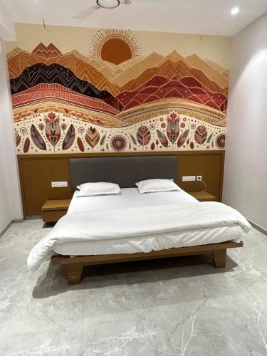 a bedroom with a large bed with a wall at LL Palace in Hinganghāt