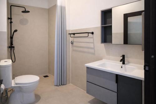 a bathroom with a toilet and a sink and a shower at Sea Sky Dreams in Kuta Lombok