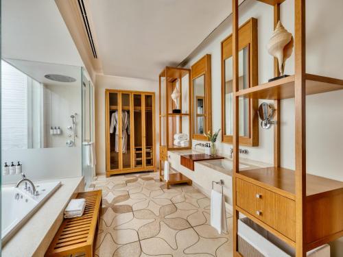 a bathroom with two sinks and a tub and a tub at InterContinental Hua Hin Resort by IHG in Hua Hin