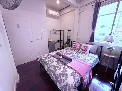 a bedroom with a bed with a tray on it at Pion Hotel Ayutthaya in Phra Nakhon Si Ayutthaya