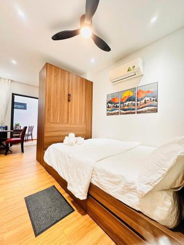 a bedroom with a bed and a ceiling fan at Happy House in Danang