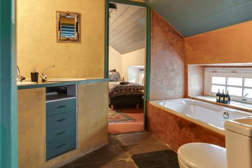 a bathroom with a tub and a sink and a toilet at Bohemian Experience Wellness, Jacuzzi, Sauna, BBQ, Garden, Sleeps 14 in Kockengen