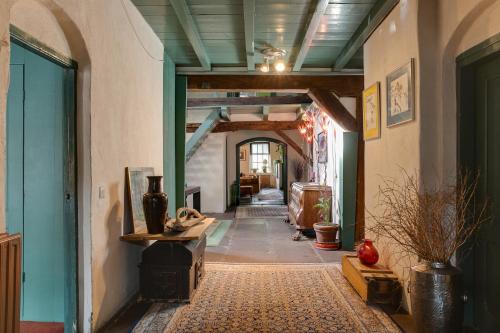 a hallway of an old building with a room with a hallway at Bohemian Experience Wellness, Jacuzzi, Sauna, BBQ, Garden, Sleeps 14 in Kockengen