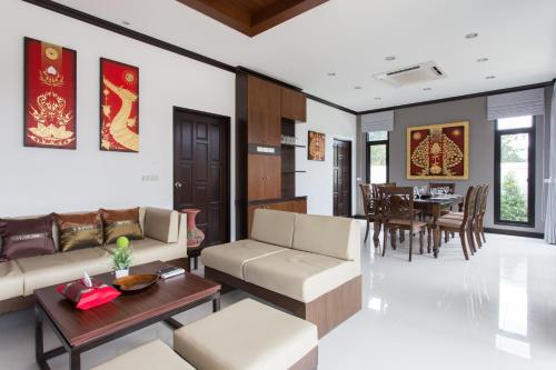 a living room with a couch and a table at The Best Ao Nang Villas in Ao Nang Beach