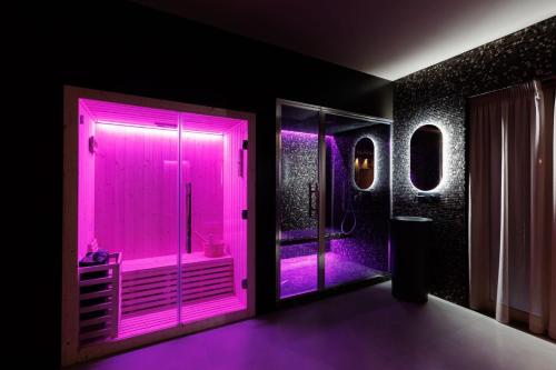 a bathroom with a pink lighted shower in a room at ZENIT Appartamenti & SPA in Terni