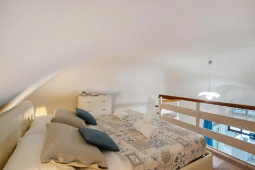 a bedroom with a bed with pillows and a staircase at La Volta Amalfi Coast in Furore