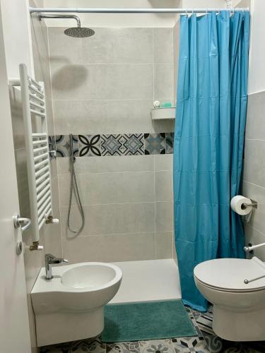 a bathroom with a shower and a toilet and a sink at Casa Ranieri in Mattinata