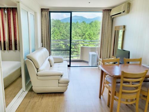 a living room with a couch and a table at Jiri Mountain Ilsung Condo in Namwon