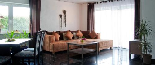 a living room with a couch and a table at Haus am Mühlberg in Modautal