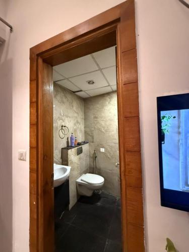 a bathroom with a toilet and a sink at Luxe Haven Stays - Luxury Studio , Premium Stay in Noida