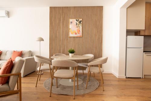a kitchen and living room with a table and chairs at ONL Apartments in Dunajská Streda
