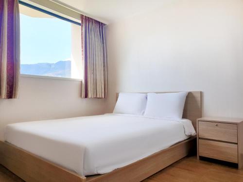 a bed in a room with a window at Jiri Mountain Ilsung Condo in Namwon
