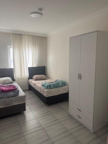 a bedroom with two beds and a dresser at Köşk Rezidans Apart in Aksaray