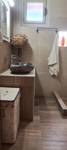 a bathroom with a sink and a toilet and a window at Casa del mare in Paralia Katerinis