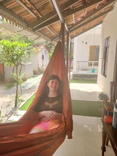 a woman is sitting in a hammock at Munroe Heritage Inn in Munroe Island