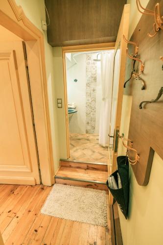 a bathroom with a glass door leading to a shower at TOMOVI HOME - Three bedrooms City center in Plovdiv