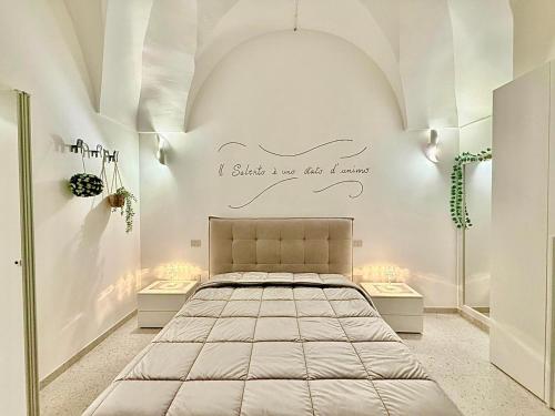 a bedroom with a bed in a white room at Casina Mameli in Nardò