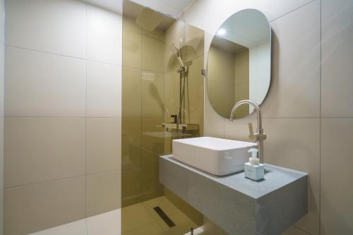 a bathroom with a sink and a mirror at Hotel Hariu in Gwangju