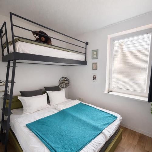 a bedroom with a bunk bed with a dog on it at Celia Center Celje Apartment in Celje