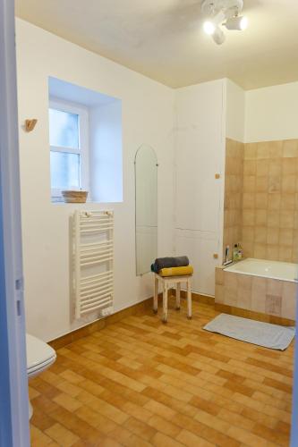 a bathroom with a tub and a toilet and a sink at La Boisselée in Saint-Dyé-sur-Loire