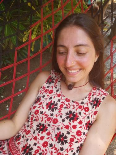 a woman in a red and black floral dress at Munroe Heritage Inn in Munroe Island