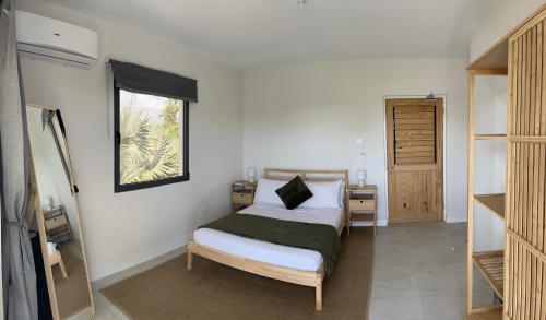 a bedroom with a bed and a window at Korah house in Saint Philip