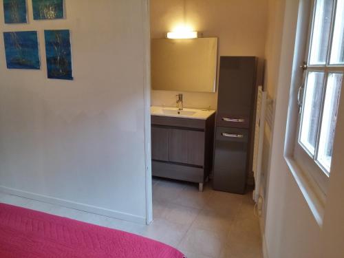 a small kitchen with a sink and a refrigerator at Appartements Cote pont Vieux-Self Check-In in Carcassonne